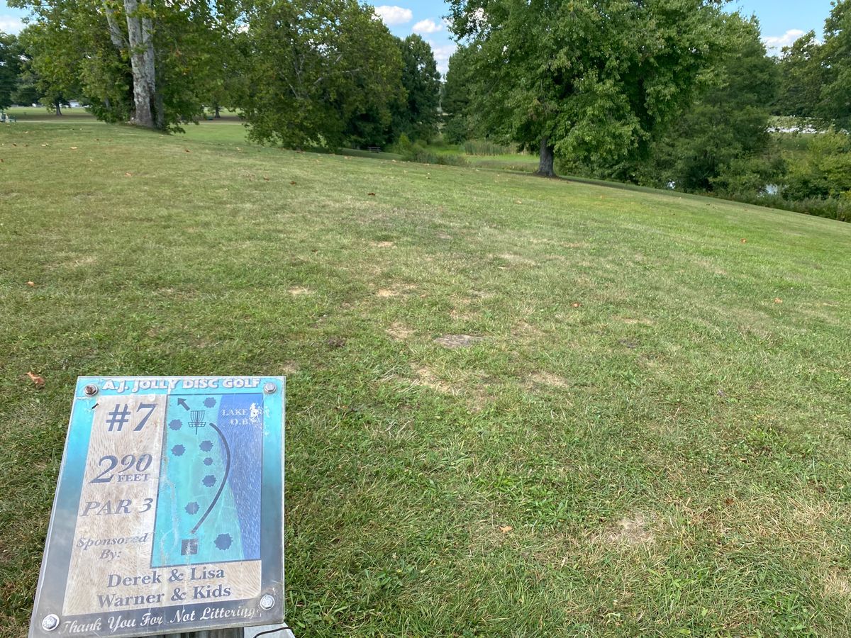 Hole 7, taken 9/4/2023.  Water in play, but easy to avoid.  Sign depicts removed tree(s).