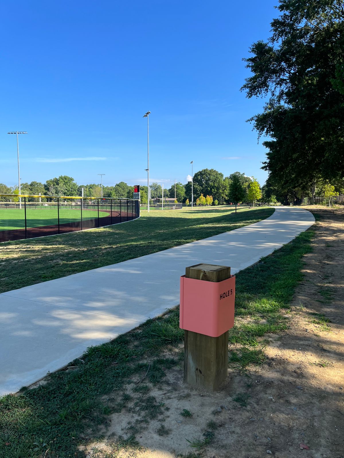 Hole 5: OB on or over sidewalk. In baseball field.