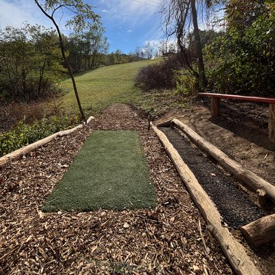 Hole 5 long tee and new cedar stained bench.