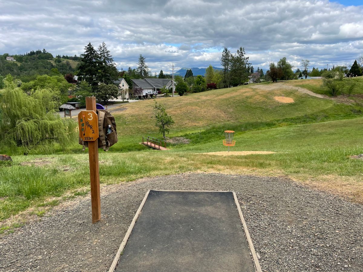 Hole 3 tee pad looking out. Basket is off to the left over the creek that runs through the park.