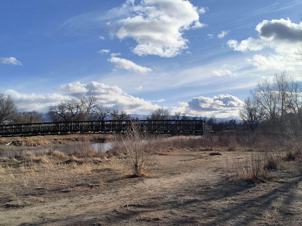 Hole 17. With the bridge over the North Platte River and Casper Mountain in the background.