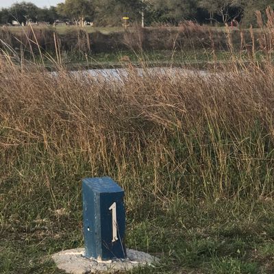 Hole one straight shot over a pond.