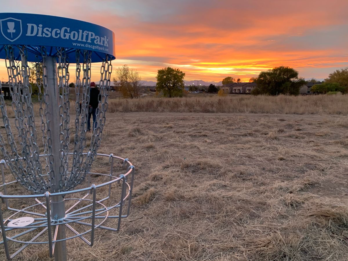 Hole 18 basket. Rocky Mountain sunset backdrop