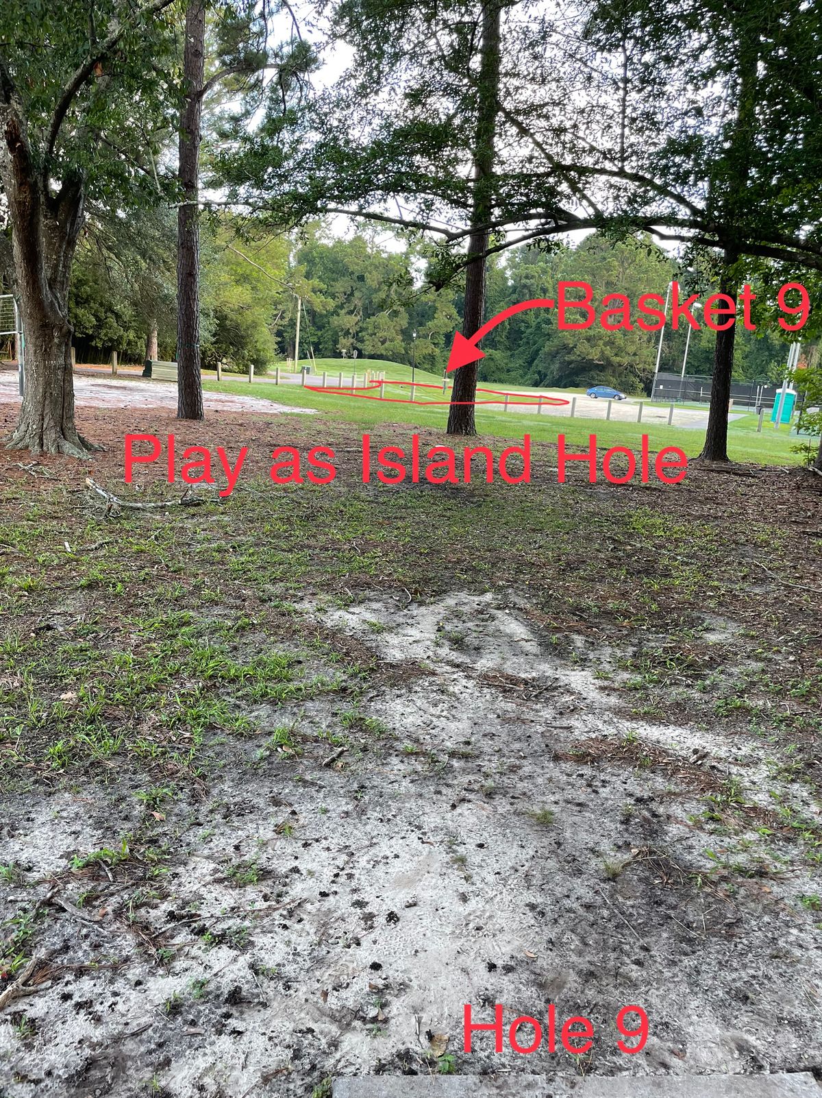 Hole 9 plays as an island hole with parking lot and street out of bounds. Watch for cars coming around the turn on the left while throwing.