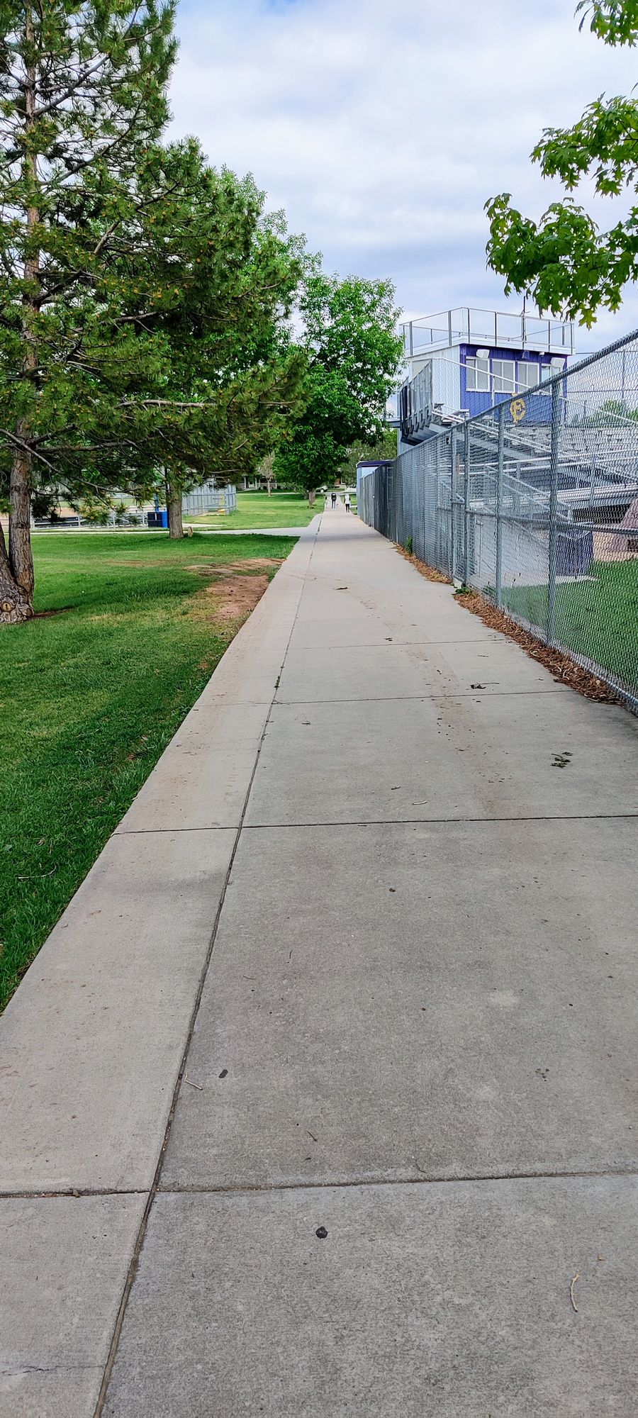 Walk down this sidewalk and turn left after the left baseball field fence to get to hole 4