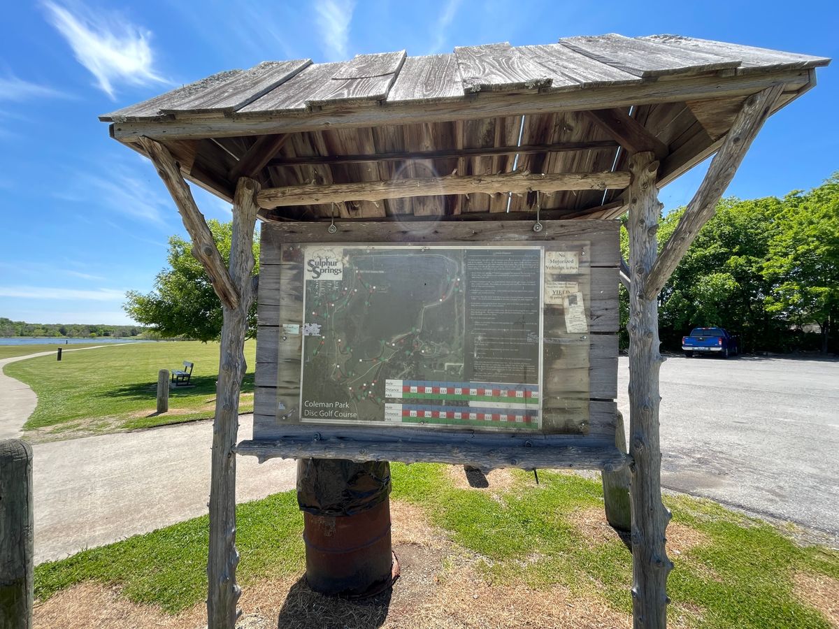 Sign by parking lot.