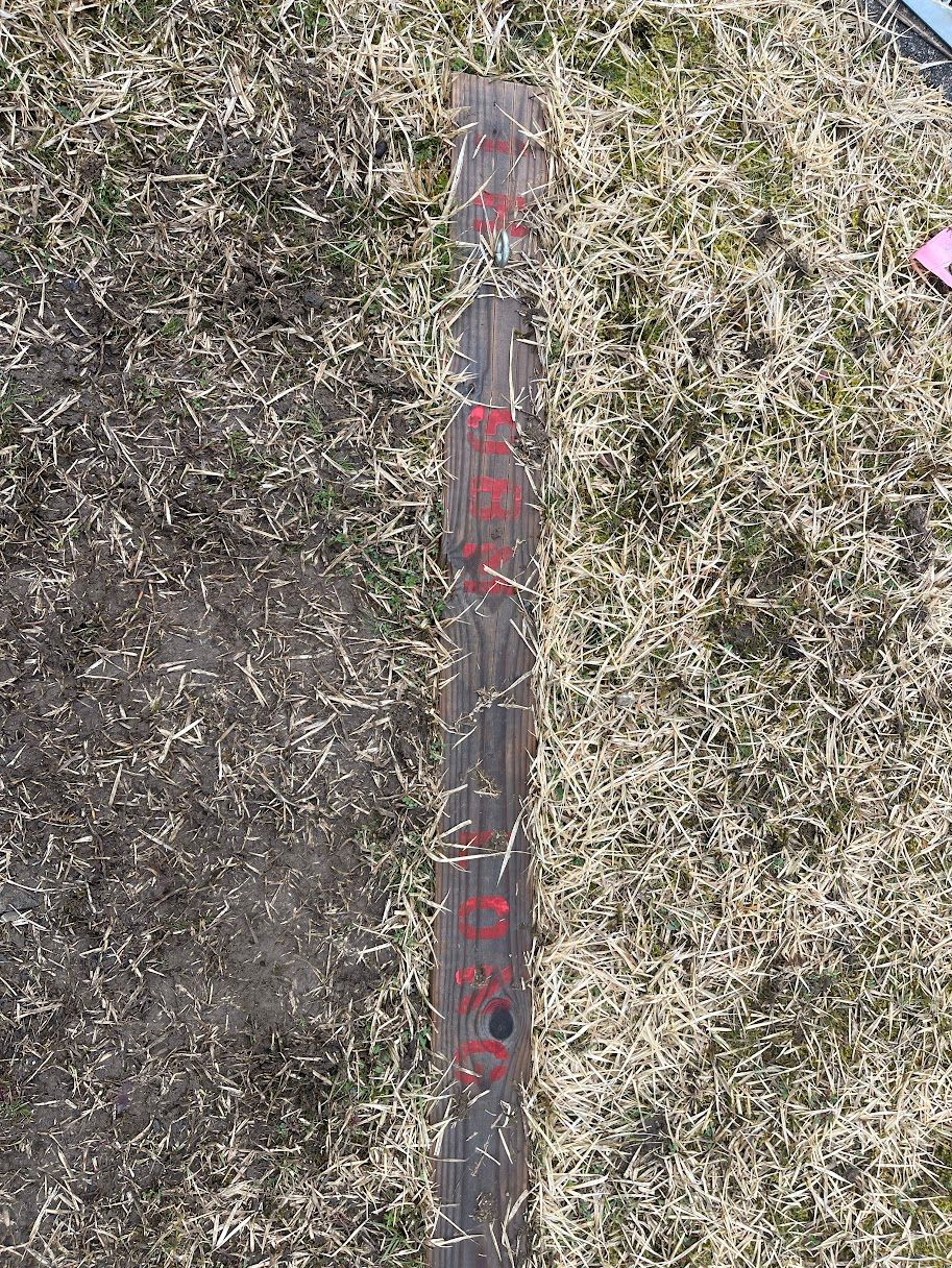 Tees are marked by wooden plank embedded in ground.