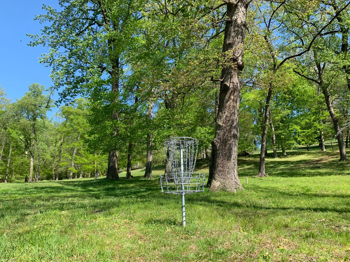 Hole 8 basket. Hole 9 tee is to the right and slightly up hill