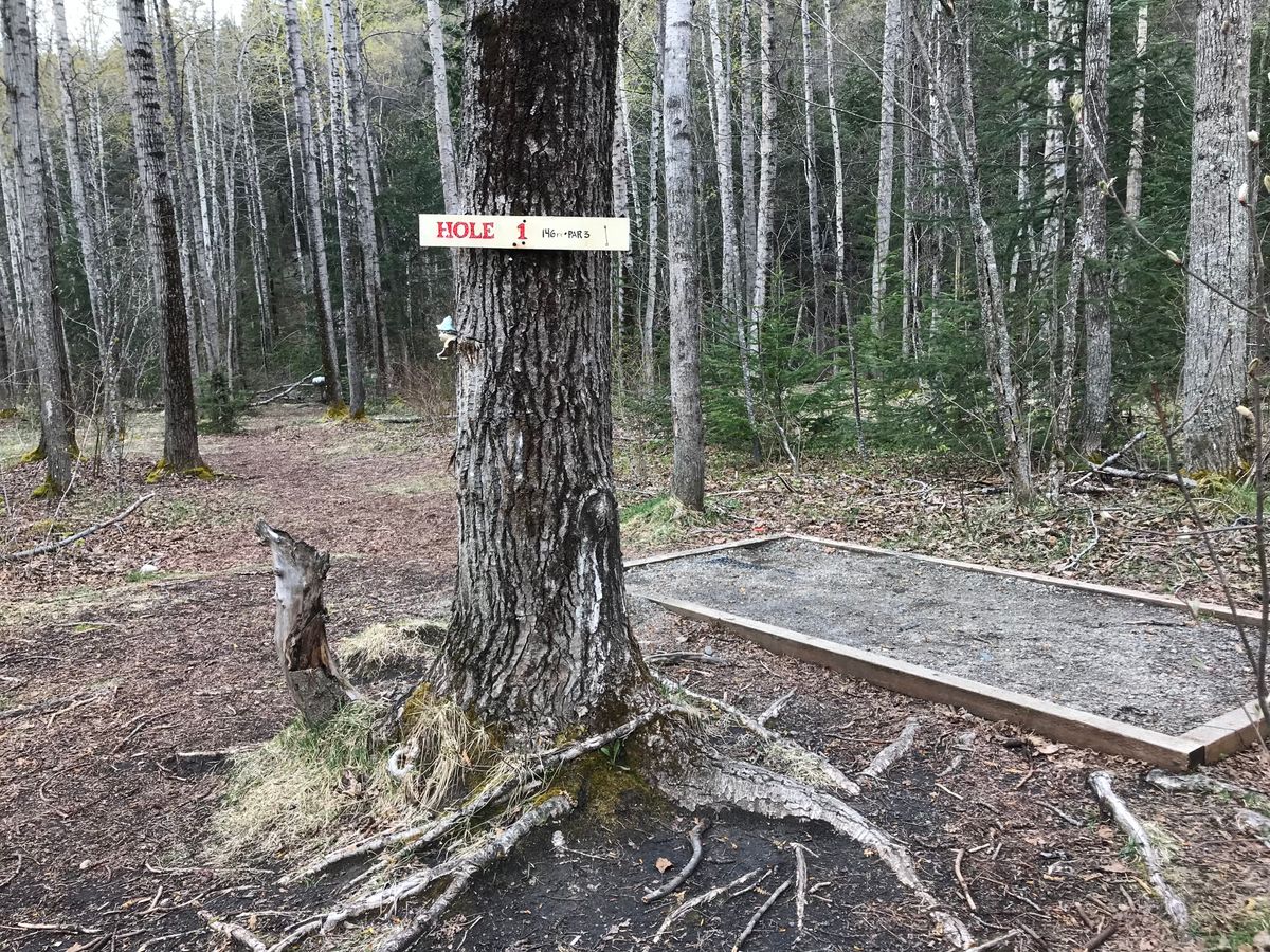 Hole 1 tee pad - a raised gravel pad with a nice sign.
