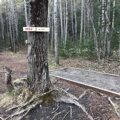 Hole 1 tee pad - a raised gravel pad with a nice sign.