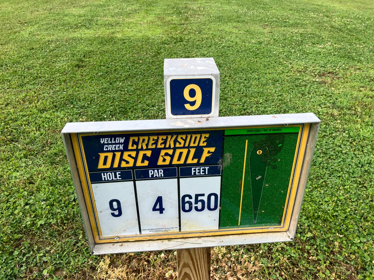 Hole 9 tee sign. over the left side fence is OB.