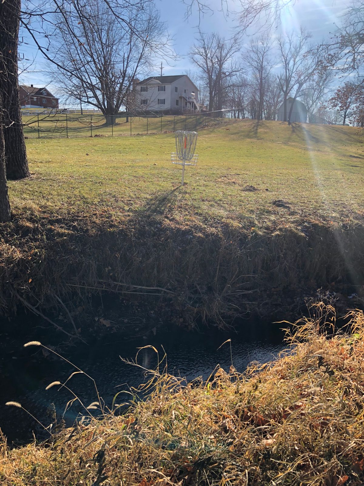 Back side of basket with creek, makes for fun death putts